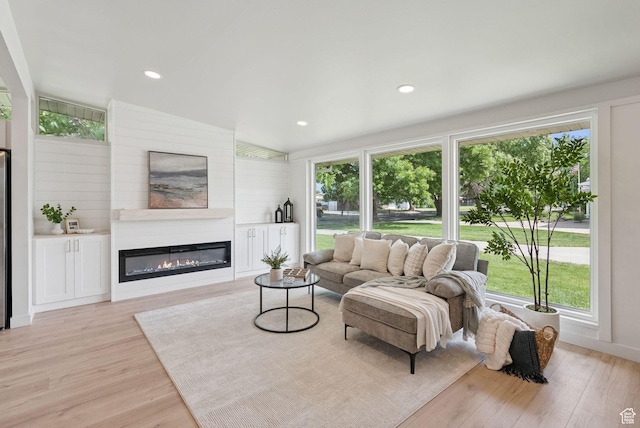 4194 S Bennion Rd, Taylorsville, UT 84129 - living room with light wood finished floors, a glass covered fireplace, plenty of natural light, and recessed lighting