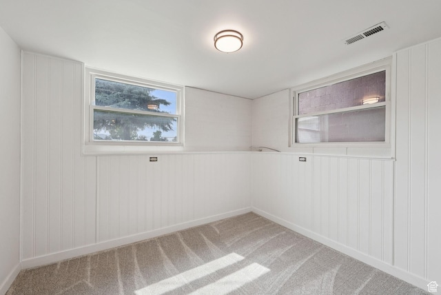 4194 S Bennion Rd, Taylorsville, UT 84129 - unfurnished room with healthy amount of natural light, light carpet, and a decorative wall