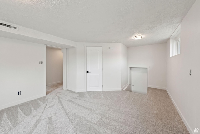 4194 S Bennion Rd, Taylorsville, UT 84129 - below grade area with a textured ceiling, baseboards, and carpet