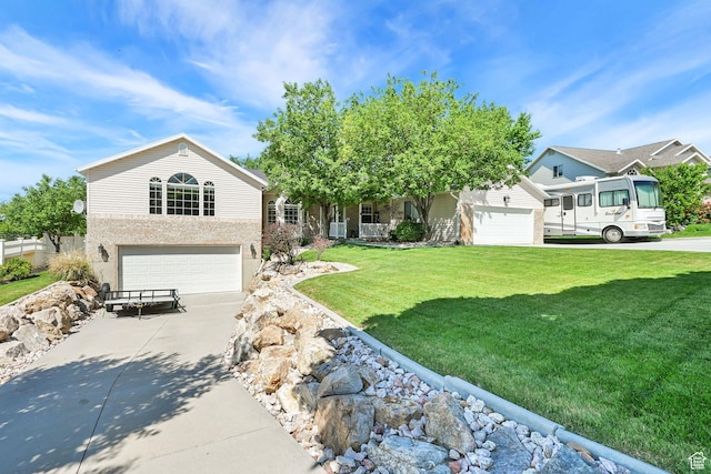 3255 N 800 E, North Ogden, UT 84414 - obstructed view of property featuring a garage, concrete driveway, and a front yard