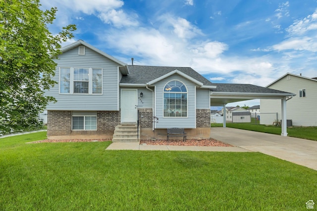4060 W 4950 S, Roy, UT 84067 - tri-level home featuring a front lawn, driveway, a carport, and brick siding