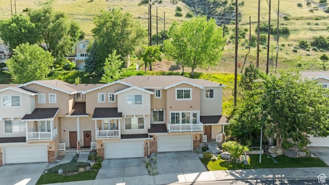 1389 S Alpine Way, Provo, UT 84606 - view of front facade with an attached garage, driveway, stucco siding, and a shingled roof