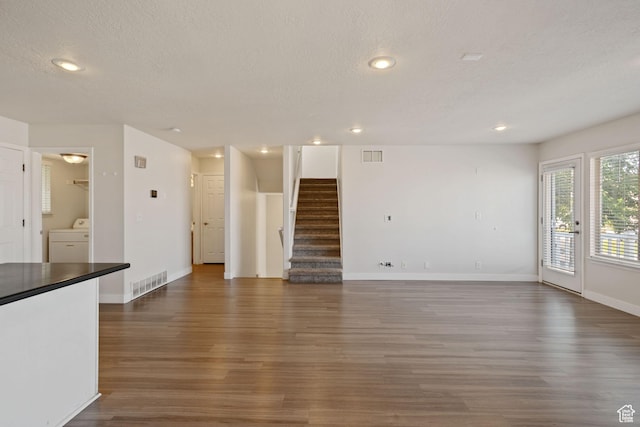 1389 S Alpine Way, Provo, UT 84606 - unfurnished living room with washer / clothes dryer, wood finished floors, a textured ceiling, stairs, and baseboards
