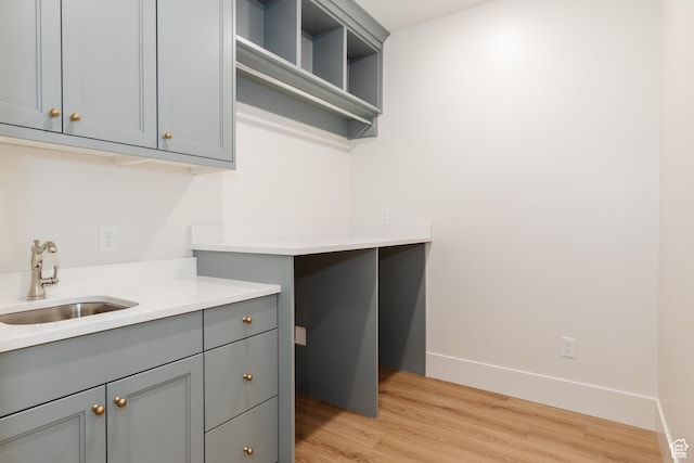 435 E 200 N, Millville, UT 84326 - washroom featuring a sink, light wood-type flooring, and baseboards