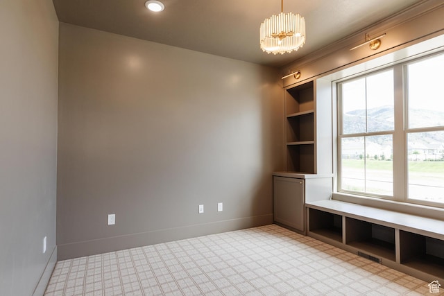 435 E 200 N, Millville, UT 84326 - spare room featuring a chandelier, baseboards, and built in shelves