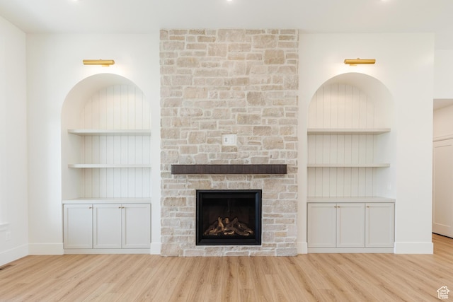 435 E 200 N, Millville, UT 84326 - unfurnished living room featuring wood finished floors, built in shelves, a fireplace, and baseboards