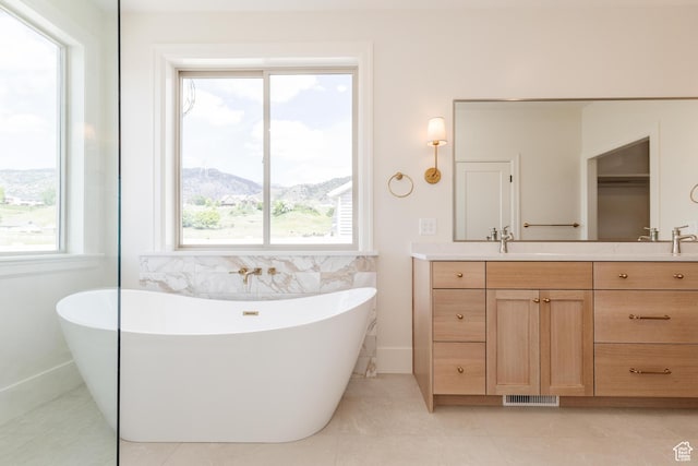 435 E 200 N, Millville, UT 84326 - full bath featuring double vanity, a soaking tub, tile patterned flooring, and a mountain view