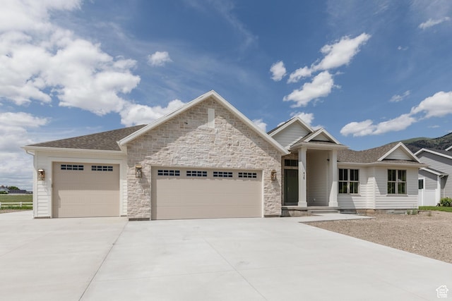 435 E 200 N, Millville, UT 84326 - view of front of home featuring a garage, concrete driveway, roof with shingles, and stone siding