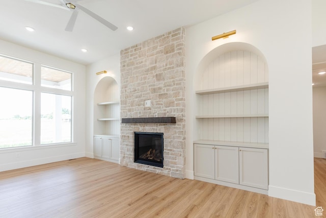 435 E 200 N, Millville, UT 84326 - unfurnished living room featuring built in features, a ceiling fan, light wood-type flooring, a fireplace, and baseboards