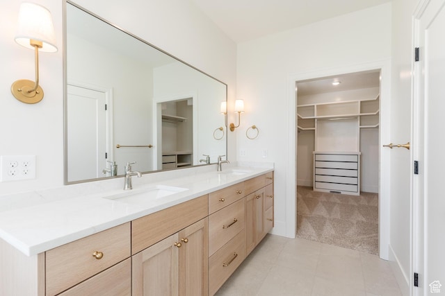 435 E 200 N, Millville, UT 84326 - bathroom featuring double vanity, a spacious closet, tile patterned floors, and baseboards