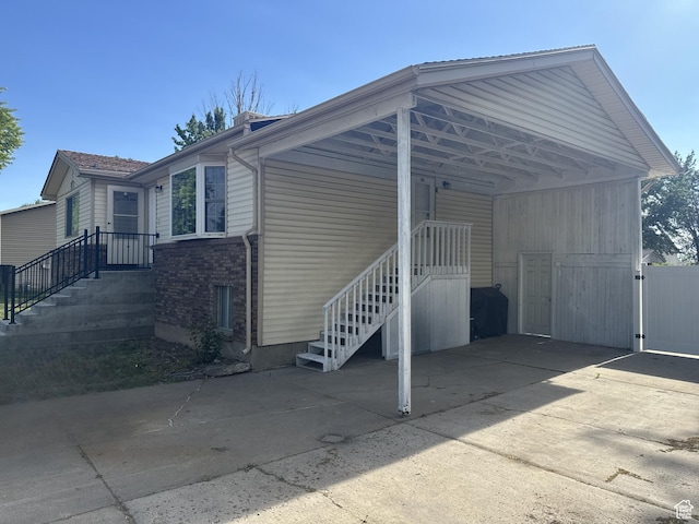 2219 N 2475 W, Clinton, UT 84015 - view of parking / parking lot featuring concrete driveway and an attached carport