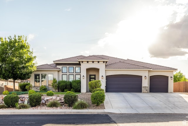 1861 N Mountain View Dr, Washington, UT 84780 - mediterranean / spanish-style house with an attached garage, stucco siding, driveway, and stone siding