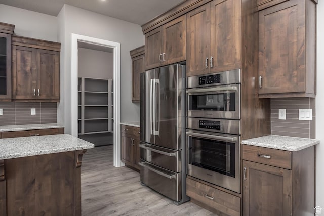 1861 N Mountain View Dr, Washington, UT 84780 - kitchen featuring stainless steel appliances, backsplash, light wood-style floors, light stone countertops, and glass insert cabinets