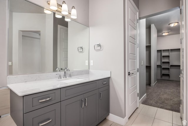 1861 N Mountain View Dr, Washington, UT 84780 - bathroom with vanity, baseboards, a walk in closet, and tile patterned flooring
