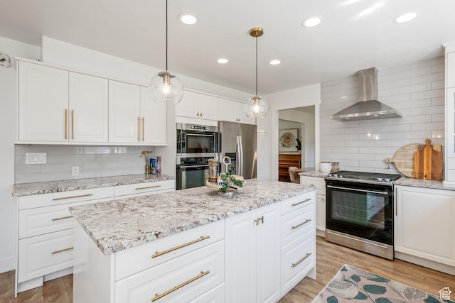 960 N E View Dr, Alpine, UT 84004 - kitchen with wall chimney exhaust hood, appliances with stainless steel finishes, backsplash, light wood-style flooring, and white cabinetry