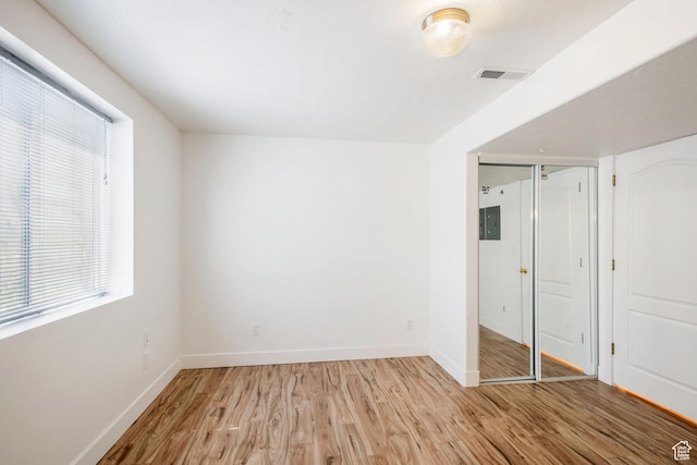 960 N E View Dr, Alpine, UT 84004 - unfurnished bedroom with light wood-style floors, multiple windows, baseboards, and electric panel