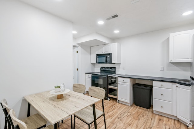 960 N E View Dr, Alpine, UT 84004 - kitchen featuring black appliances, white cabinets, dark countertops, light wood-style flooring, and recessed lighting
