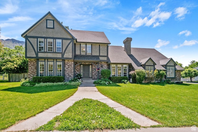 960 N E View Dr, Alpine, UT 84004 - tudor home featuring stucco siding, a chimney, and brick siding