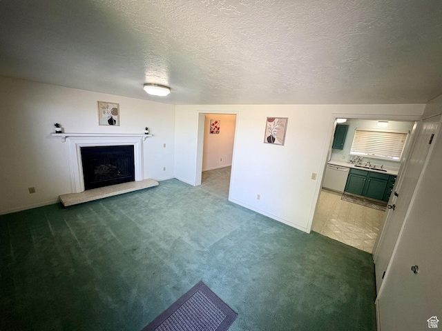 391 N 100 W, Delta, UT 84624 - unfurnished living room featuring carpet, a fireplace with raised hearth, baseboards, a textured ceiling, and a sink