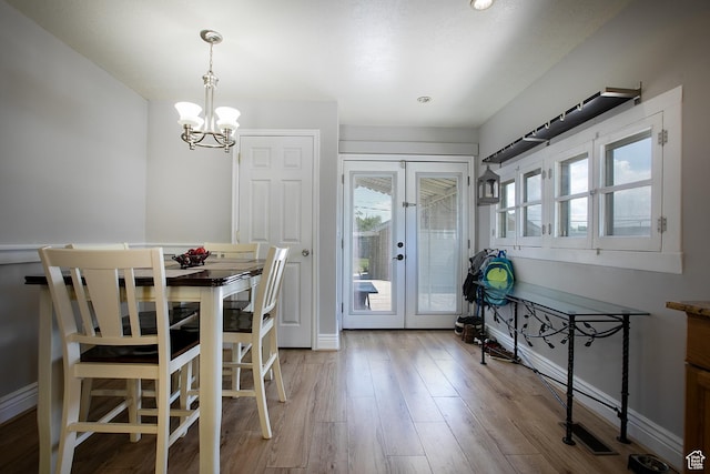 1438 E Woodland Ave S, Millcreek, UT 84106 - dining area with a chandelier, french doors, and light wood finished floors