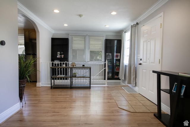 1438 E Woodland Ave S, Millcreek, UT 84106 - entryway with wood finished floors, crown molding, arched walkways, and recessed lighting