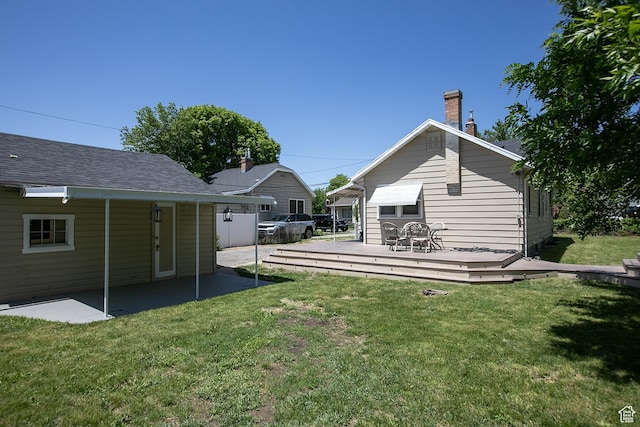 1438 E Woodland Ave S, Millcreek, UT 84106 - rear view of property featuring a wooden deck, a yard, and a chimney