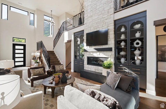 1040 S Summit Creek Dr, Woodland Hills, UT 84653 - living room featuring wood finished floors, stairway, a fireplace, baseboards, and a high ceiling