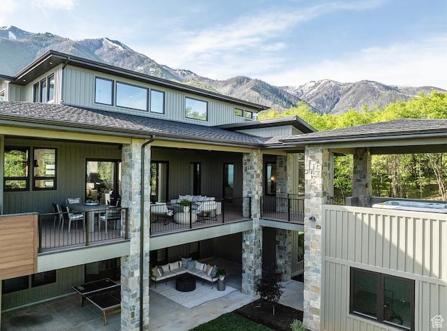 1040 S Summit Creek Dr, Woodland Hills, UT 84653 - back of property featuring a mountain view, stone siding, an outdoor hangout area, a patio, and roof with shingles