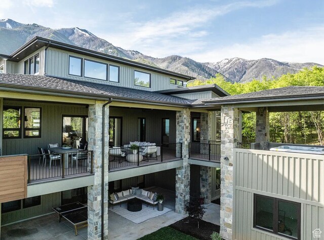 1040 S Summit Creek Dr, Woodland Hills, UT 84653 - back of property featuring a mountain view, stone siding, an outdoor hangout area, a patio, and roof with shingles