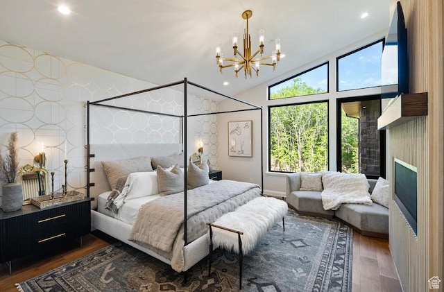 1040 S Summit Creek Dr, Woodland Hills, UT 84653 - bedroom featuring wood finished floors, a chandelier, lofted ceiling, wallpapered walls, and a fireplace