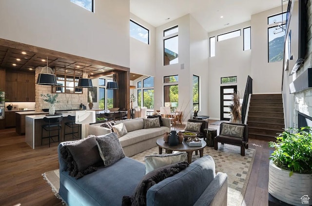 1040 S Summit Creek Dr, Woodland Hills, UT 84653 - living room with hardwood / wood-style flooring, plenty of natural light, a high ceiling, and stairs