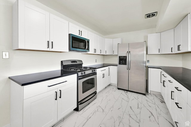 5151 S 2275 W, Roy, UT 84067 - kitchen featuring stainless steel appliances, light marble finish floors, dark countertops, and white cabinets