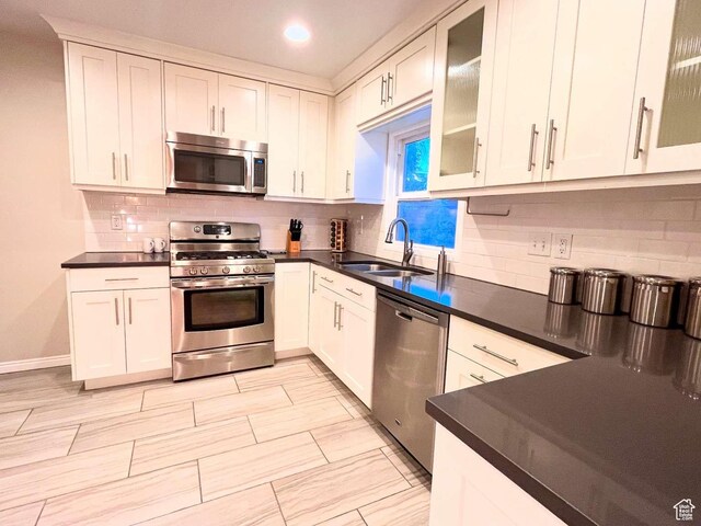 2326 E 1700 S, Salt Lake City, UT 84108 - kitchen featuring stainless steel appliances, a sink, dark countertops, backsplash, and recessed lighting