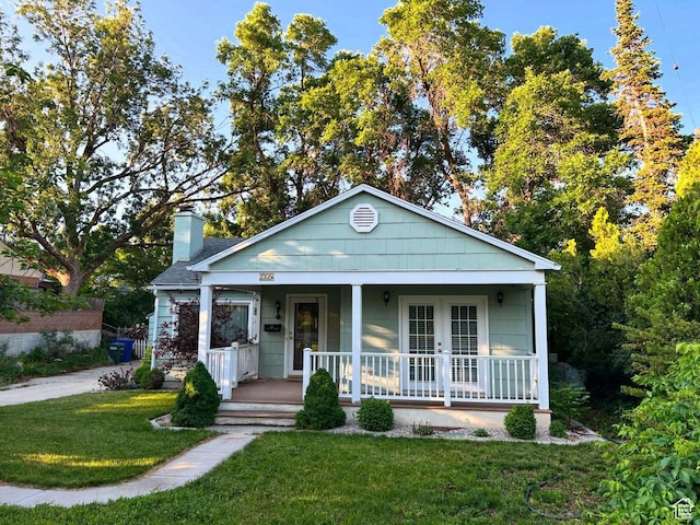 2326 E 1700 S, Salt Lake City, UT 84108 - bungalow-style home featuring covered porch, a front lawn, and a chimney