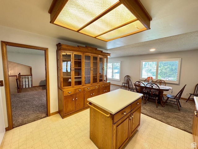 6209 W 9600 N, Highland, UT 84003 - kitchen with light colored carpet, brown cabinetry, light flooring, and baseboards