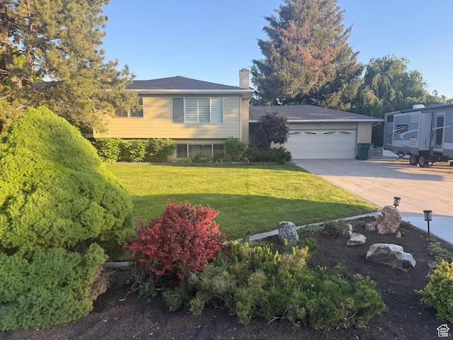 6209 W 9600 N, Highland, UT 84003 - tri-level home with a chimney, driveway, a garage, and a front lawn