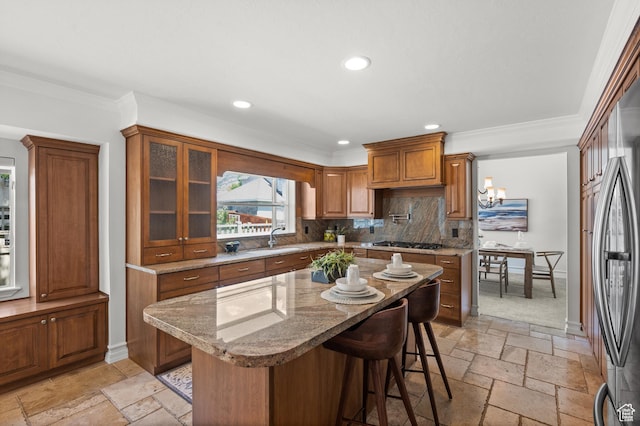2607 E Cruise Bay Ct Unit 406, Cottonwood Heights, UT 84121 - kitchen featuring stone tile flooring, brown cabinetry, gas cooktop, a sink, and recessed lighting