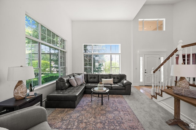 2607 E Cruise Bay Ct Unit 406, Cottonwood Heights, UT 84121 - living room featuring a high ceiling, plenty of natural light, stairs, and carpet