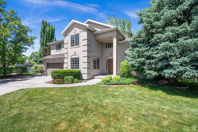 2607 E Cruise Bay Ct Unit 406, Cottonwood Heights, UT 84121 - view of front of house featuring an attached garage, concrete driveway, stucco siding, and a front lawn