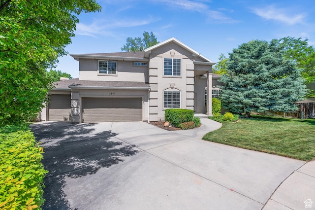 2607 E Cruise Bay Ct Unit 406, Cottonwood Heights, UT 84121 - view of front of home with stucco siding, driveway, and a garage