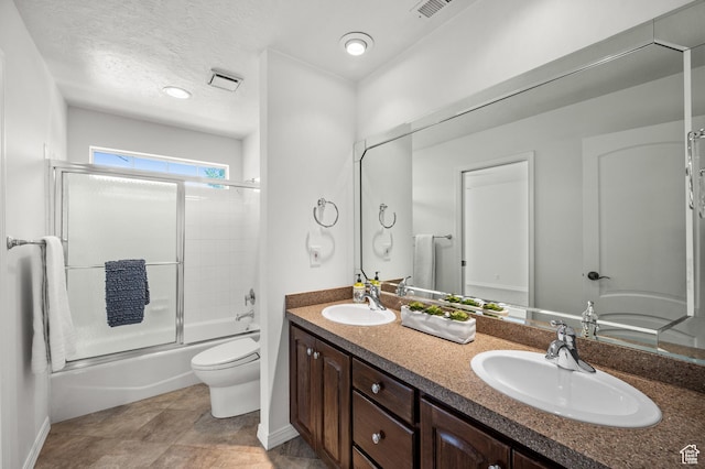 2607 E Cruise Bay Ct Unit 406, Cottonwood Heights, UT 84121 - full bathroom featuring toilet, double vanity, shower / bath combination with glass door, baseboards, and a textured ceiling