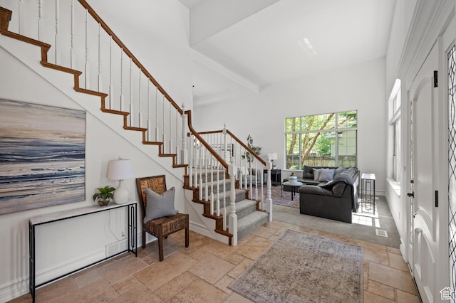 2607 E Cruise Bay Ct Unit 406, Cottonwood Heights, UT 84121 - entrance foyer with stone tile flooring, stairway, and a towering ceiling