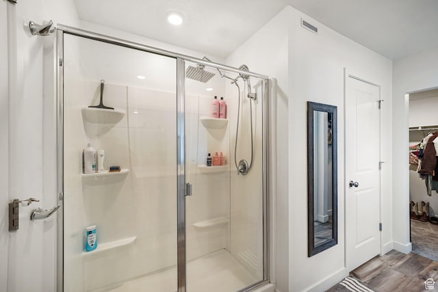 3493 N Sparrow Ln, Eagle Mountain, UT 84005 - bathroom with a shower stall, wood finished floors, a walk in closet, and recessed lighting