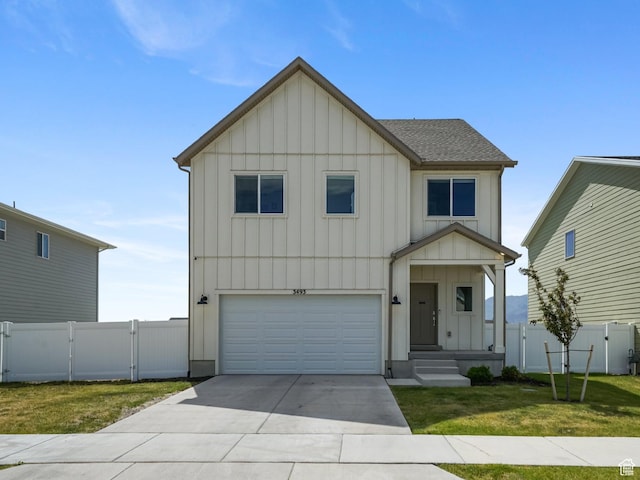 3493 N Sparrow Ln, Eagle Mountain, UT 84005 - view of front of property with board and batten siding, a gate, concrete driveway, and an attached garage