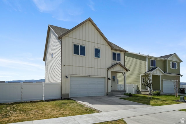 3493 N Sparrow Ln, Eagle Mountain, UT 84005 - view of front of home with board and batten siding, a garage, a gate, driveway, and roof with shingles