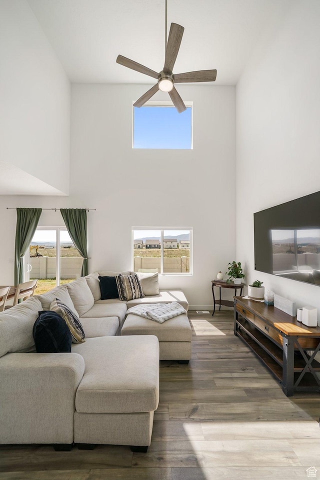 3493 N Sparrow Ln, Eagle Mountain, UT 84005 - living area featuring a towering ceiling, a ceiling fan, and wood finished floors