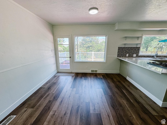 1516 E 36th, Ogden, UT 84403 - unfurnished dining area with a textured ceiling, a sink, dark wood-style floors, and baseboards