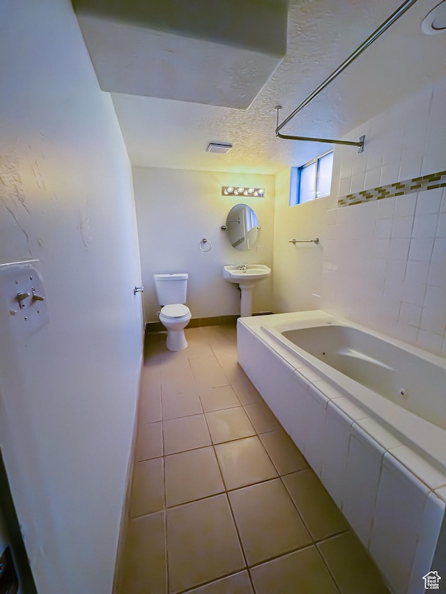 1516 E 36th, Ogden, UT 84403 - bathroom with toilet, tile patterned flooring, baseboards, a combined bath / shower with jetted tub, and a textured ceiling