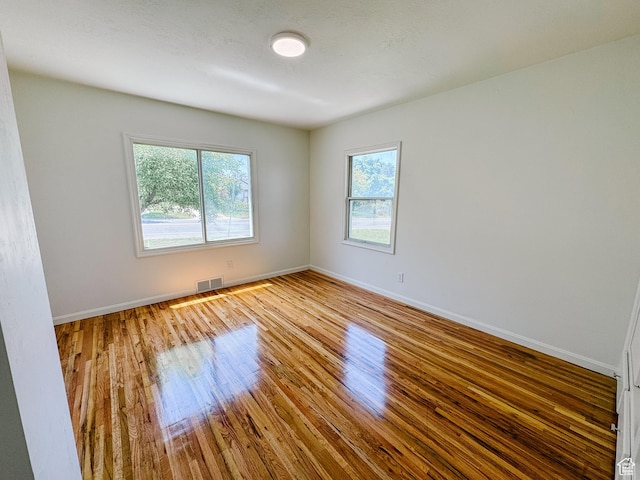 1516 E 36th, Ogden, UT 84403 - spare room with plenty of natural light, wood finished floors, and baseboards