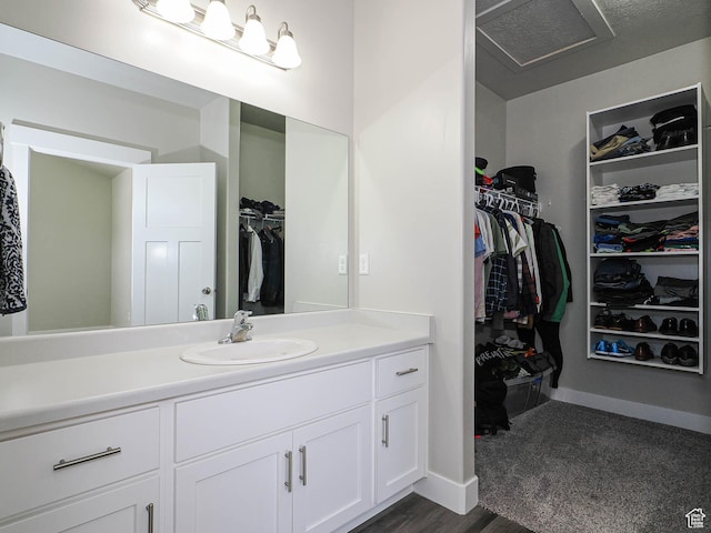 14654 S Bloom Dr W Unit K 304, Herriman, UT 84096 - bathroom featuring vanity, a spacious closet, and baseboards